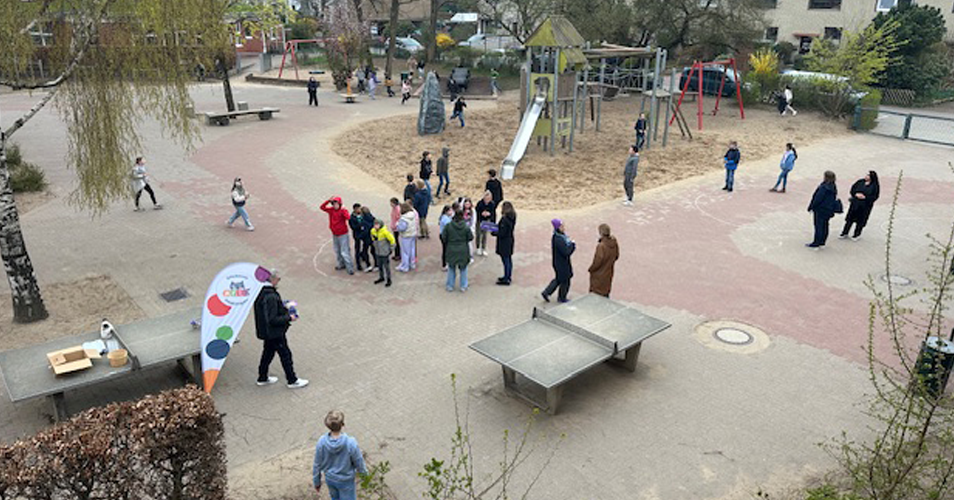Kinder suchen auf dem Schulhof Osterhasen und Ostereier